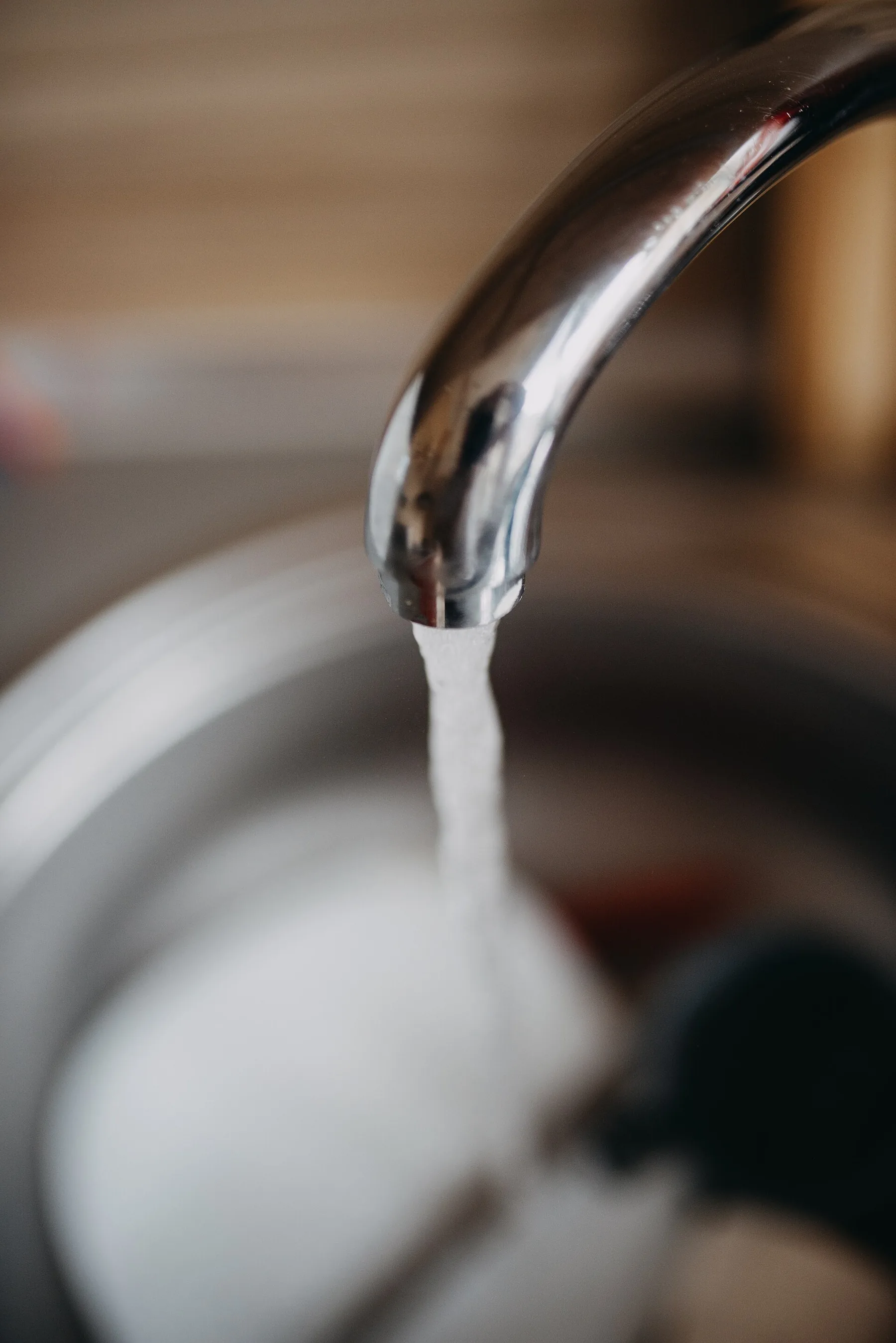 Agua corriendo en un fregadero de cocina durante el día